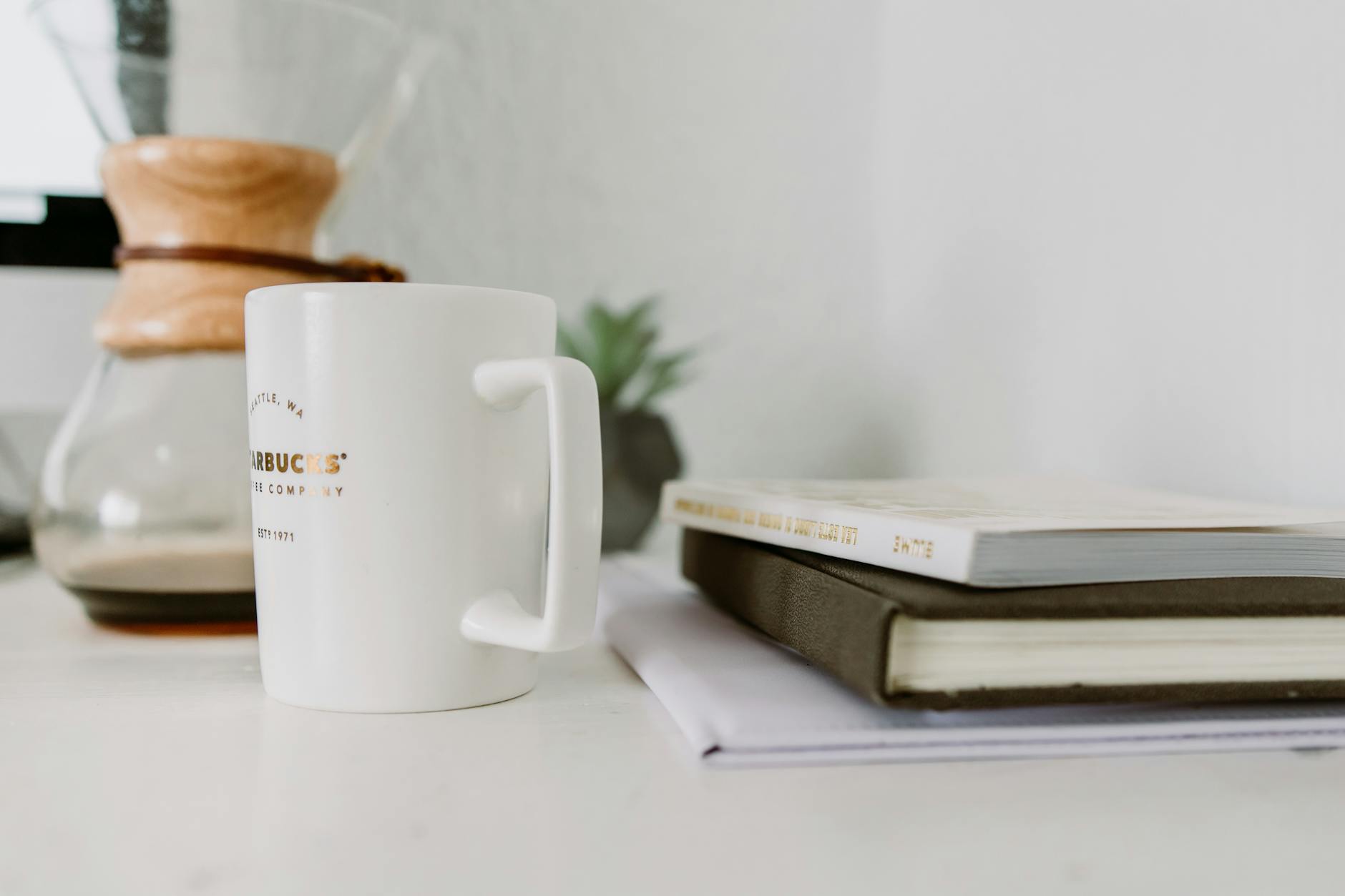 white mug near book